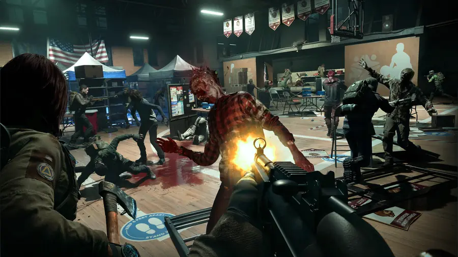 A player fires a rifle across a gymnasium while a teammate swings an axe